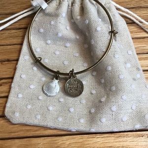 Shell charm bracelet with quote.